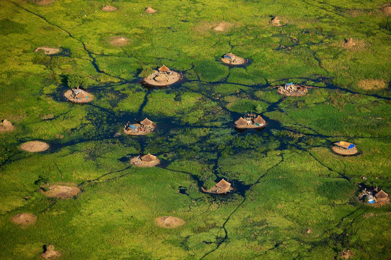 © Yann Arthus-Bertrand - Village in the White Nile swamps near Bor, Jonglei, South Sudan (6°22’ N – 31°32’ E).